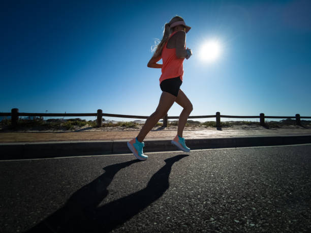 istock Blonde girl, woman active & running on road 1222400640