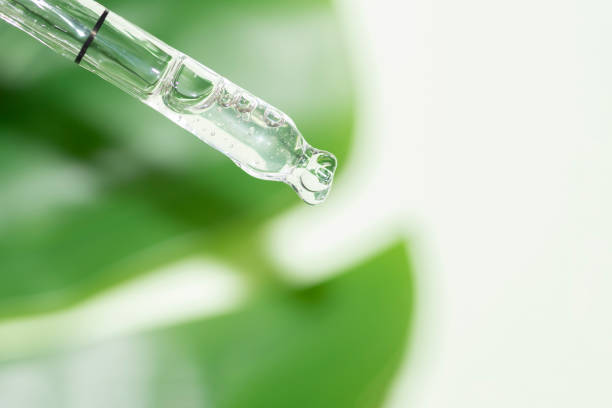 istock macro of pipette with liquid and drop with monstera leaf in background 1222400925