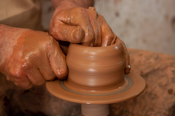 istock Hands of a potter, creating an earthen jar on the circle. 1222405328