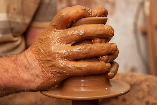 istock Hands of a potter, creating an earthen jar on the circle. 1222406668