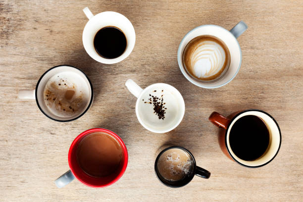 istock Many cups of coffee on wooden table, top view 1222406896