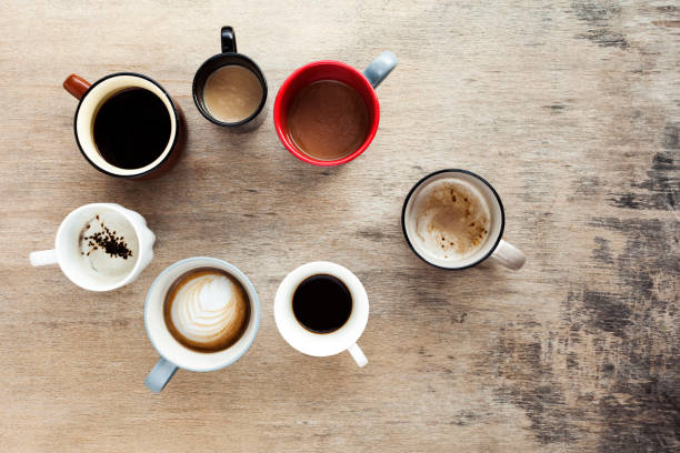 istock Many cups of coffee on wooden table, top view 1222406901