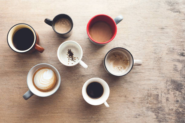 istock Many cups of coffee on wooden table, top view 1222406928