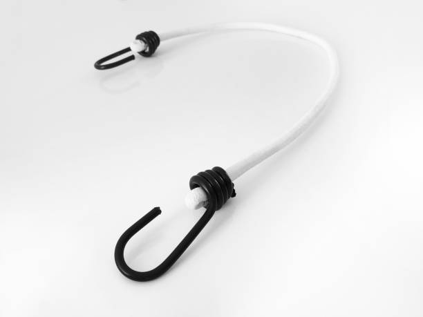 istock Aerial view of Elastic white strap with hook on the end isolated on white background.Universal elastic with black hooks holding objects. 1222408625