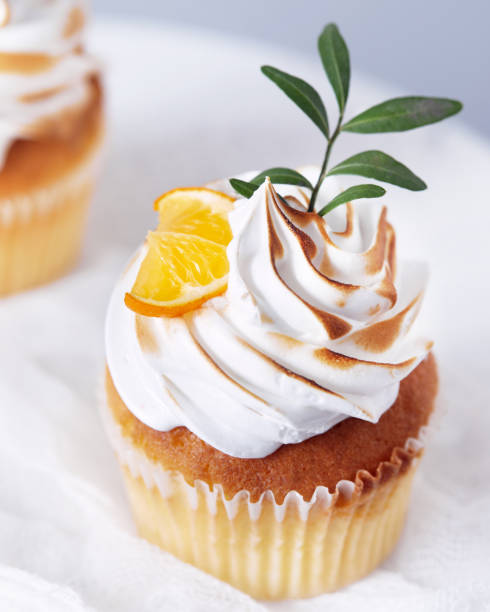 istock Homemade cupcakes decorated with lemon and leaves on white background 1222409827