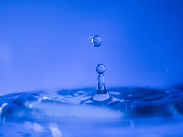 istock Water drop creating waves ripples and air borne water droplet 1222410942