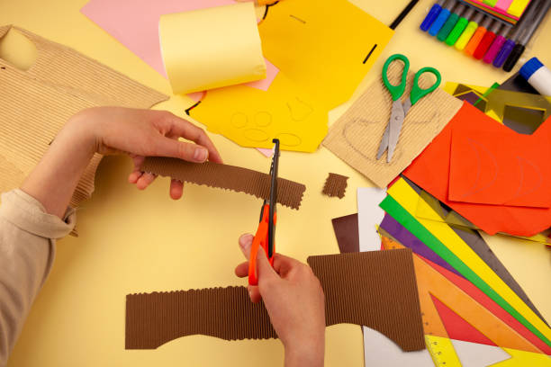 istock Step 16. Step-by-step instructions on how to make a stand for stationery from recycled materials. Do it yourself. A glass for pencils and pens from a plastic bottle and a can. A fun craft for kids DIY 1222411376