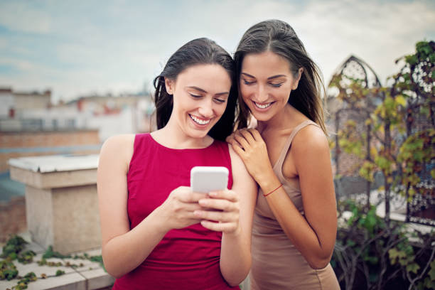 istock Young women are texting on a roof terrace 1222412868
