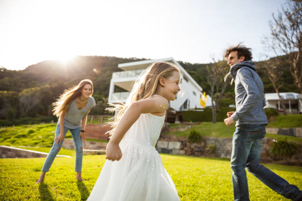 istock Parents and girl out in the backyard playing together while in quarantine 1222415374
