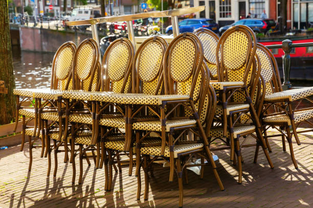 istock stacked chairs at a canal in Amsterdam, Netherlands 1222416845
