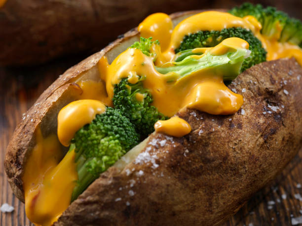 Cheese and Broccoli Stuffed Potatoes Cheese and Broccoli Stuffed Potatoes cheese sauce stock pictures, royalty-free photos & images