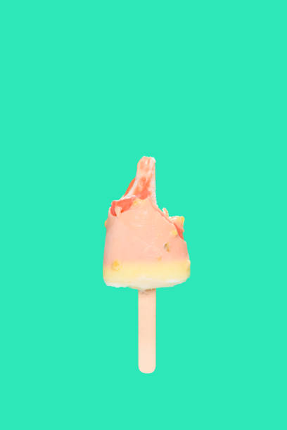 istock mostly eaten white chocolate outer popsicle with red inner on green background 1222419630