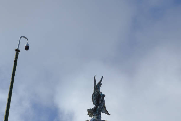 istock Statue with wings with a blue sky background and clouds.  Winged statue with a blue sky and clouds background 1222419670