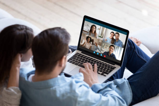 istock Young couple talk on video call with diverse friends 1222422948