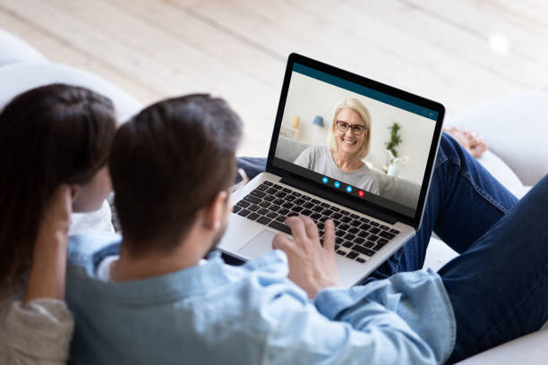 istock Young couple talk on video call with elderly mother 1222422975