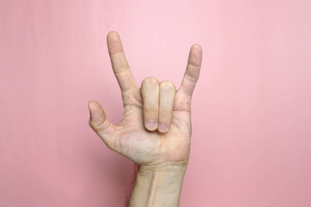 istock Male hand with fair skin shows a gesture, hand on a light pink background 1222422980