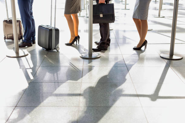 istock Business people queueing for check in at airport 1222424243