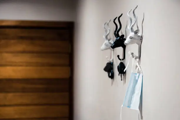 carkeys and mask hanging on hooks the new normal