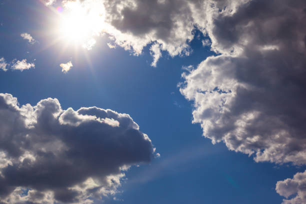 istock blue sky with white clouds and with the shining sun 1222425435