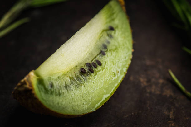 Fresh and ripe sliced kiwi on the rustic background