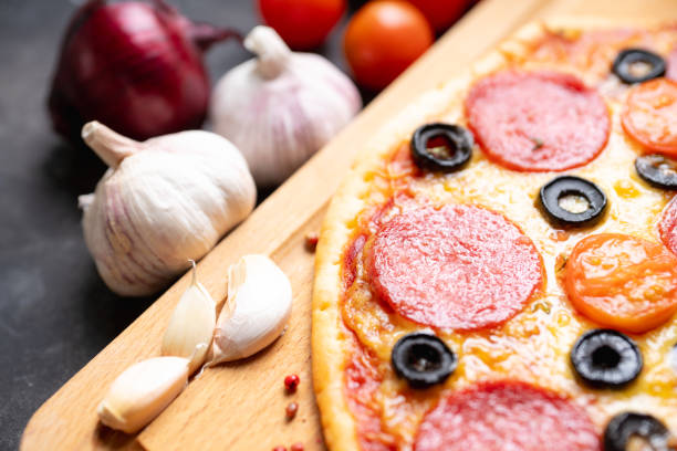 istock Fresh pepperoni pizza served on the rustic background 1222427860