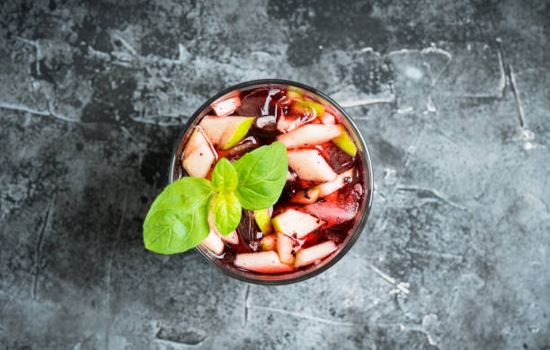 istock Old fashioned cocktail with blackberry liqueur and apple slices on rustic background 1222427883