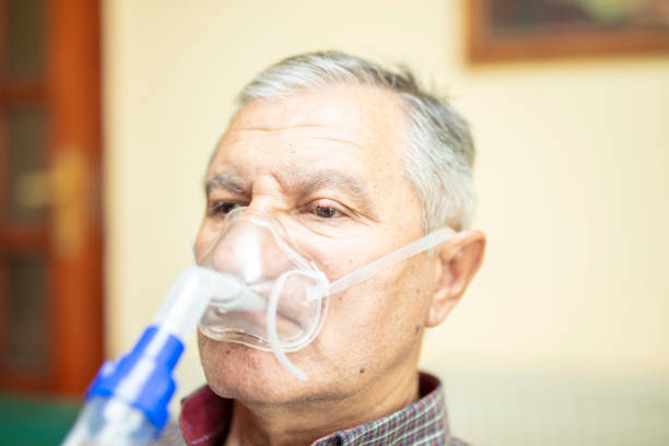 istock Senior man using medical equipment for inhalation with respiratory mask, nebulizer 1222427968