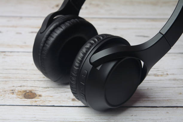 istock Modern professional headphones isolated on wooden table 1222427983