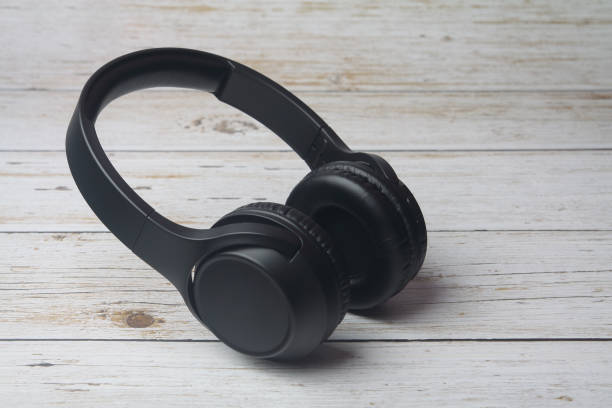 Modern professional headphones isolated on wooden table