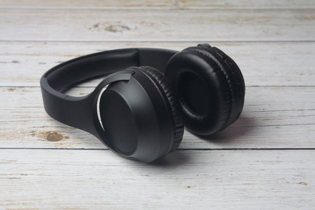 istock Modern professional headphones isolated on wooden table 1222428641