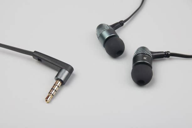 istock Earphones lying on the blue background 1222429512