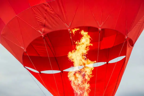 Red air balloon in the moment of burning fire