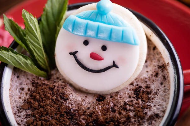 christmas concept snowman cookie in hot cocoa chocolate red mug