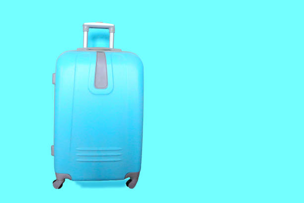 istock Blue suitcase isolated on blue. Travel concept, banner. Copy space for the text 1222432499