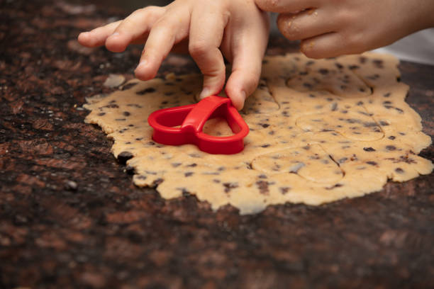 istock Close-up child`s hands preparing cookies 1222432606