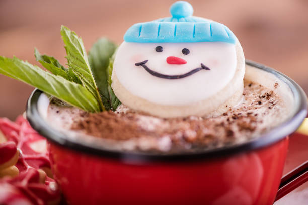 christmas concept snowman cookie in hot cocoa chocolate red mug