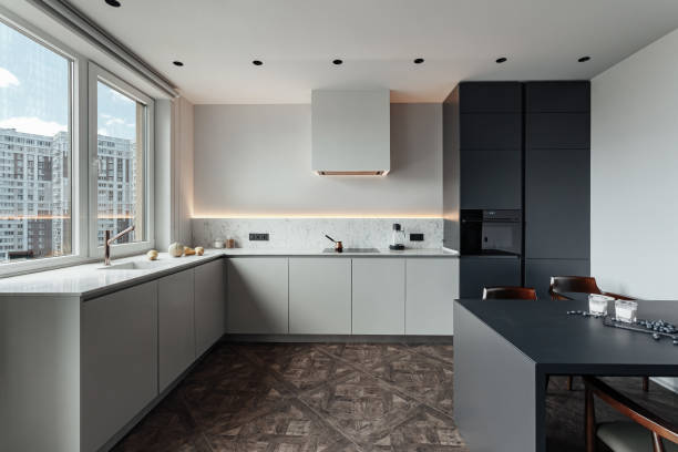 istock bright kitchen with dark table, convenient location of kitchen accessories and equipment, modern style, White walls, marble working surface and parquet floor. There s a glass of milk on the table and a blueberry 1222435520
