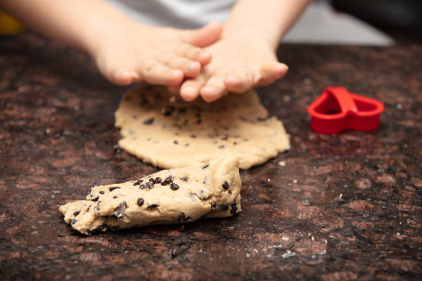 istock Close-up child`s hands preparing cookies 1222435553