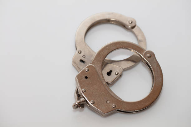 istock steel metal Handcuffs on  white background isolate 1222435696