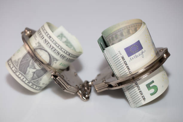 istock Dollar and euro Bills With Handcuffs 1222436817