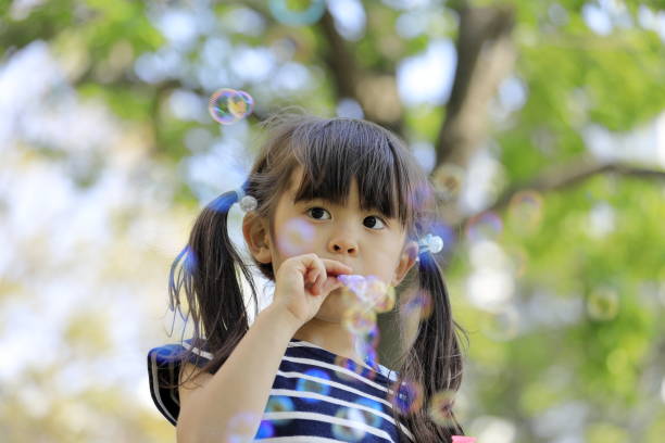 istock Japanese girl playing with bubble in the green (5 years old) 1222437740