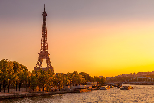 Eiffel tower and the Seine river with a sunset in the backgrouds