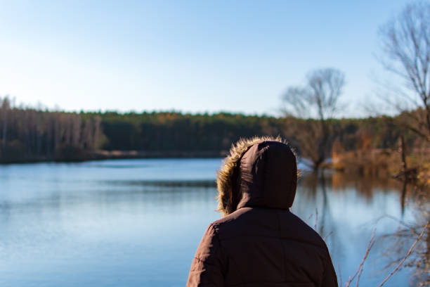 istock Woman overviewing a lake while autumn 1222445306