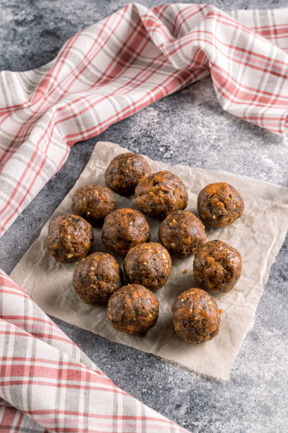 istock Fruit and nut energy balls on parchment paper, flat lay. 1222446037