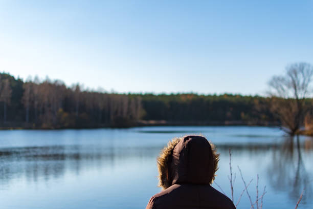istock Woman overviewing a lake while autumn 1222447025