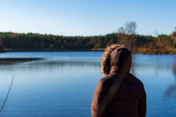 istock Woman overviewing a lake while autumn 1222447248