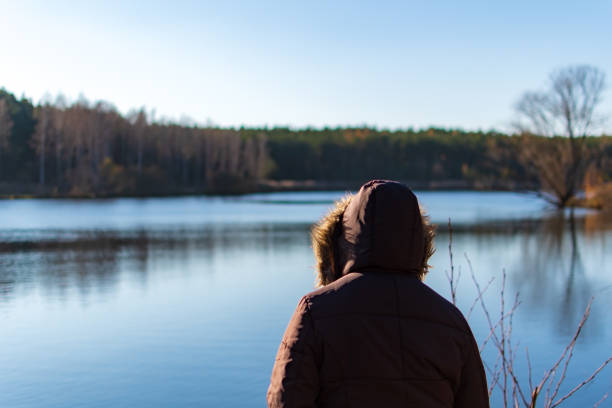 istock Woman overviewing a lake while autumn 1222447626