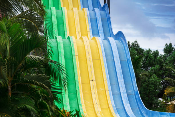 Couple having fun and sliding down in a water slide