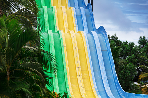 water slides in tropical waterpark on a sunny day
