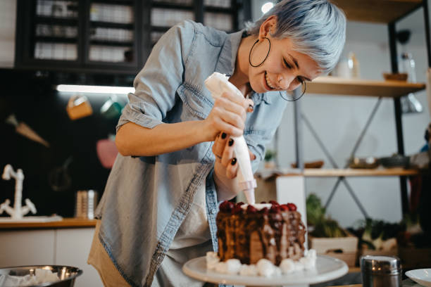 istock Woman decorating homemade cake 1222451249